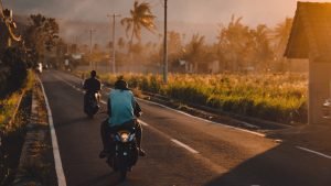 2 people riding on motor cycles